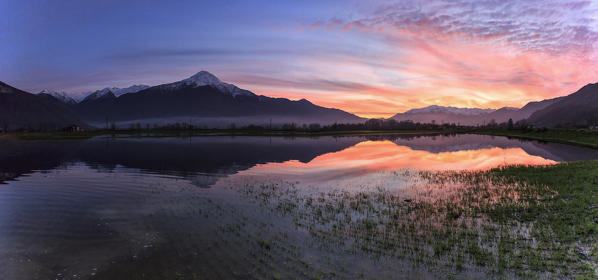Panoramic view of Pian di Spagna flooded with Mount Legnone reflected in the water at sunset Valtellina Lombardy Italy Europe