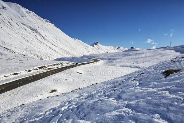 The road runs through the snow covered valley Albula Pass Bergün Canton of Graubünden Engadine Switzerland Europe