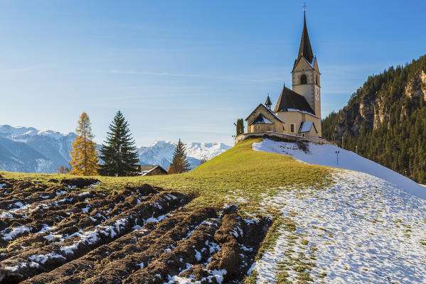The church of the little village of Schmitten surrounded by snow Albula District Canton of Graubünden Switzerland Europe