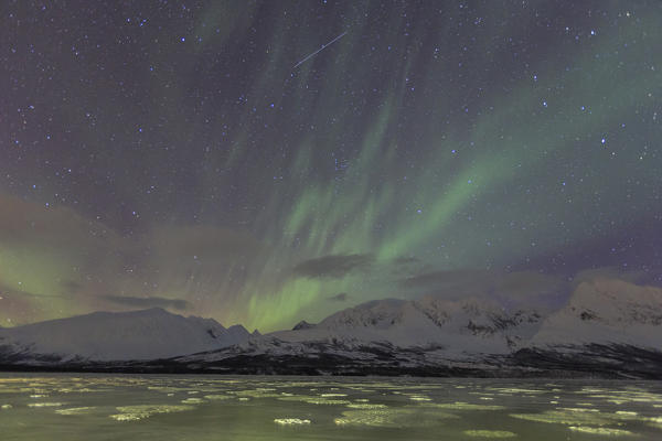 Northern Lights on the icy landscape of Svensby Lyngen Alps Tromsø Lapland Norway Europe