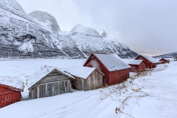 Typical wooden huts in the snowy landscape of Lyngseidet Lyngen Alps Tromsø Lapland Norway Europe