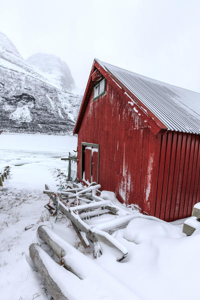 Typical wooden cabin in the snowy landscape of Lyngseidet Lyngen Alps Tromsø Lapland Norway Europe