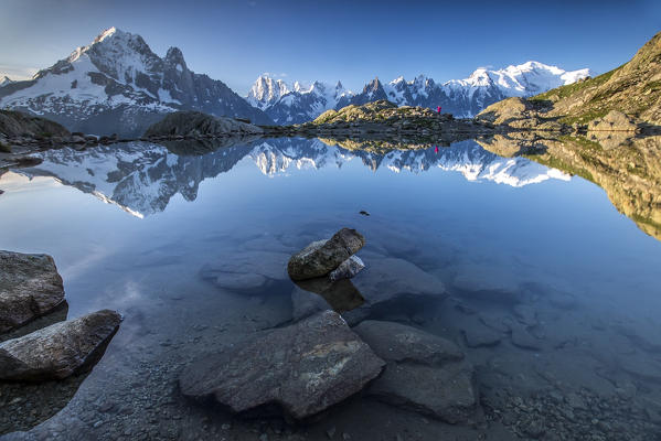 Snowy peaks of Aiguilles Verte Dent Du Geant and Mont Blanc are reflected in Lac Blanc Haute Savoie France Europe