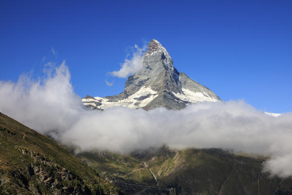 View of Matterhorn framed by clouds and blue sky in a summer day Gornergrat Valais Switzerland Europe