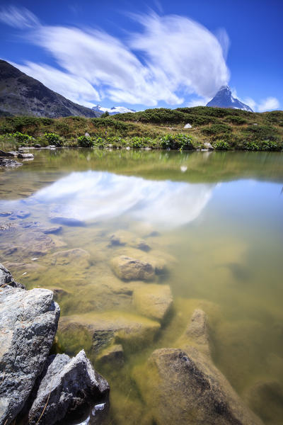 Summer clouds and the Matterhorn are reflectedi in Lake Leisee Zermatt Canton of Valais Switzerland Europe