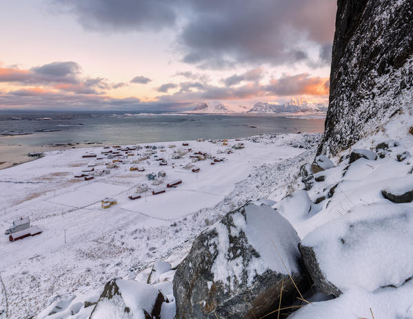 The fishing village surrounded by snow and cold sea under a colorful sky Eggum Vestvagøy Island Lofoten Islands Norway Europe