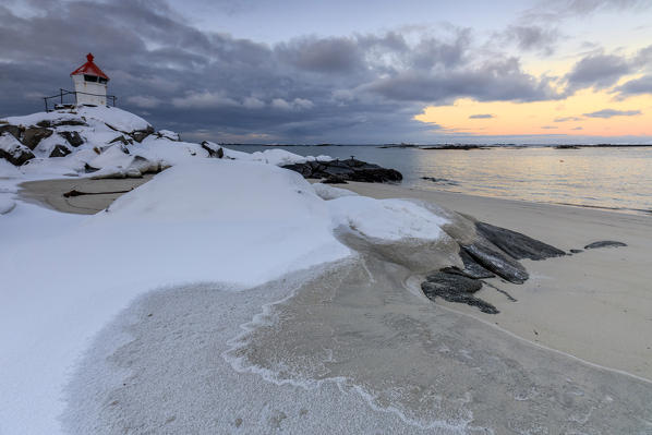 The blue arctic dusk on the lighthouse surrounded by snow and icy sand Eggum Vestvagoy Island Lofoten Islands Norway Europe