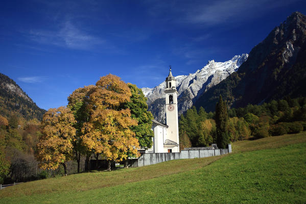 Autumn in Bondo and view of its church. Bregaglia Valley Switzerland. Europe