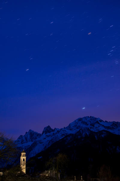 Night view of the church in Soglio and the peaks of Cengalo and Badile. Bregaglia Valley. Switzerland Europe