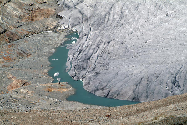 A glacial lake formed at the front of Fellaria glacier following his summer melting. Valmalenco. Valtellina Lombardy. Italy Europe