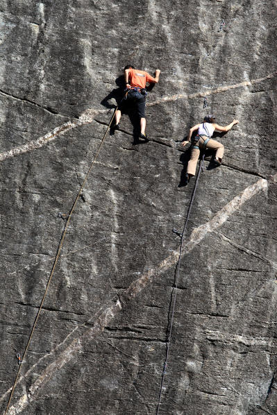 Climbers on the plaques of Sasso Remenno. Valmasino. Valtellina. Lombardy Italy Europe