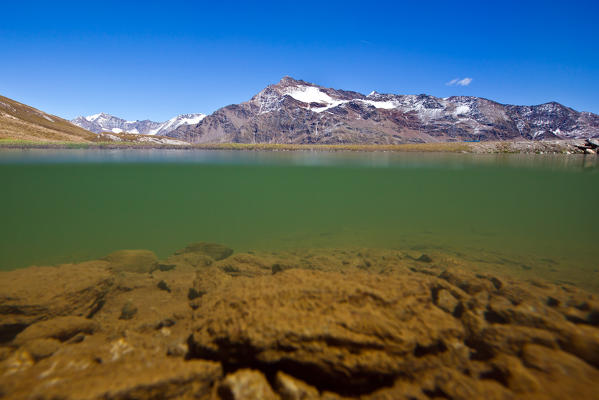 Semi diver shooting to Alpe Laghetto a small body of water in front of Tresero peak. Valfurva High Valtellina. Lombardy. Italy Europe