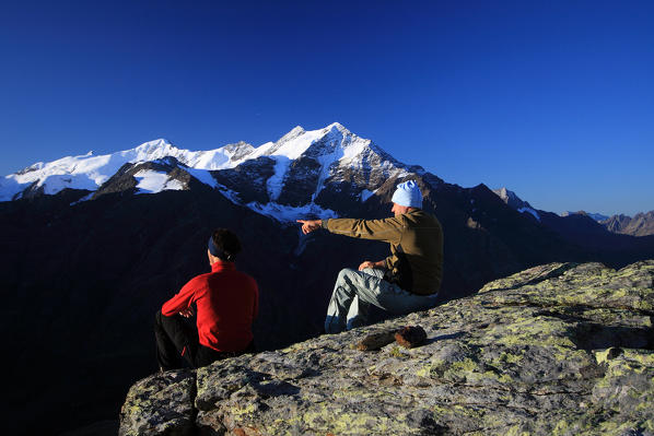 Hikers admire the landscape of Tresero peak and Forni glacier. Valfurva High Valtellina. Lombardy. Italy Europe