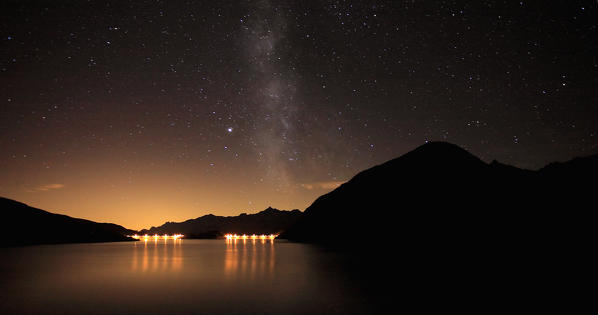 The Milky Way appears above the dam Montespluga on a summer night. Valchiavenna. Vallespluga. Valtellina. Lombardy. Italy. Europe 