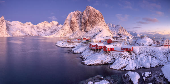 Panoramic view of snowy peaks and frozen sea at dawn around the fishing village Hamnoy Nordland Lofoten Islands Norway Europe