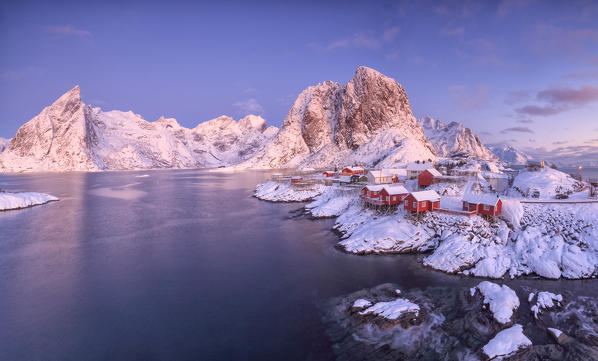 Panoramic view of snowy peaks and frozen sea at dawn around the fishing village Hamnoy Nordland Lofoten Islands Norway Europe