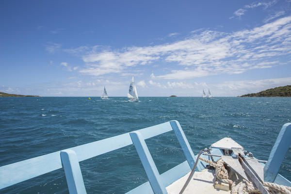 Boats sailing in the turquoise waters of the Caribbean Sea Green Island Antigua and Barbuda Leeward Island West Indies