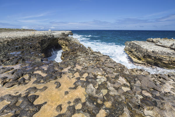 Waves in the natural arches of limestone carved by sea Devil's Bridge Caribbean Antigua and Barbuda Leeward Islands West Indies