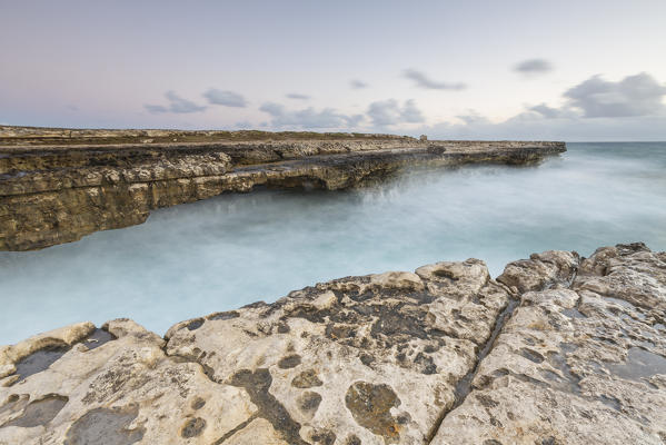 Waves crashing on natural arches carved by the sea at Devil's Bridge Caribbean Antigua and Barbuda Leeward Islands West Indies