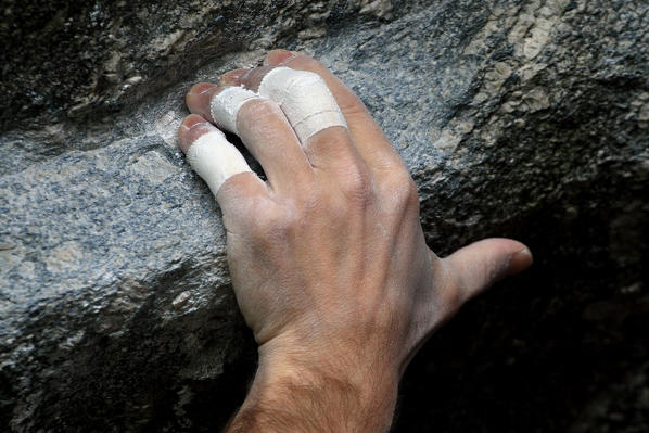 The hand of a climber at the Sasso Remenno in Valmasino, Valtellina, Lombardy Italy Europe