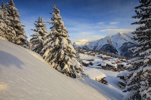 Sunset frames the mountain huts and woods covered with snow Bettmeralp district of Raron canton of Valais Switzerland Europe