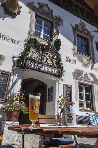 A typical alpine restaurant and glass of German beer Garmisch Partenkirchen Oberbayern region Bavaria Germany Europe