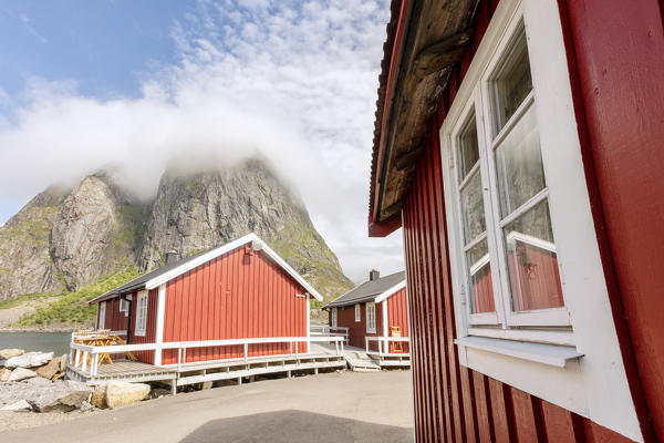 Typical houses of fishermen called Rorbu framed by peaks Hamnøy Moskenes Nordland county Lofoten Islands Northern Norway Europe