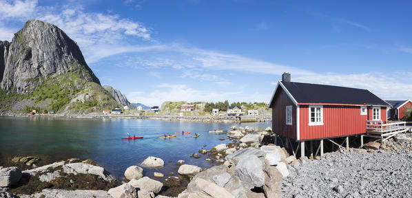 Panorama of the fishing village framed by blue sea and high peaks Hamnøy Moskenes Nordland county Lofoten Islands Norway Europe