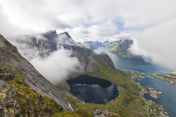 Top view of lakes and sea under the cloudy sky at summer Reinebringen Moskenes Lofoten Islands Norway Europe