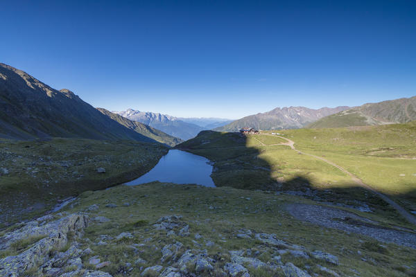 View of Rifugio Bozzi framed by the blue alpine  lake Val Di Viso Camonica Valley province of Brescia Lombardy Italy Europe