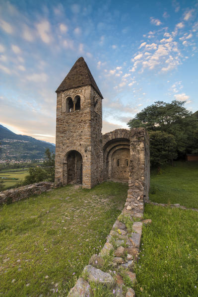 Pink clouds at sunset on the old Abbey of San Pietro in Vallate Piagno Sondrio province Lower Valtellina Lombardy Italy Europe