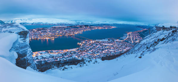 Panoramic view of the city of Tromsø at dusk from the mountain top reached by the Fjellheisen cable car Northern Norway Europe