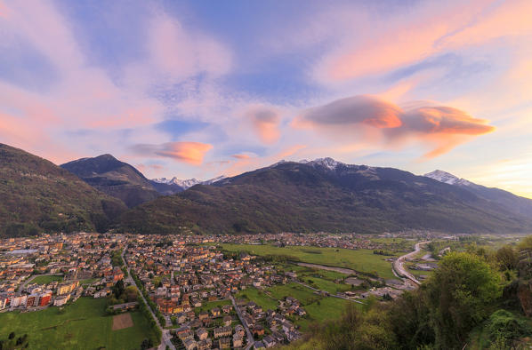 The pink sky at sunset frames the town of Morbegno province of Sondrio Lombardy Valtellina Italy Europe