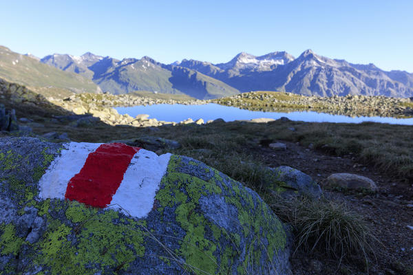 Signage of hiking trails on rocks, Lake Bergsee, Spluga Valley, Spluga Pass, province of Sondrio, Lombardy, Valtellina, Italy