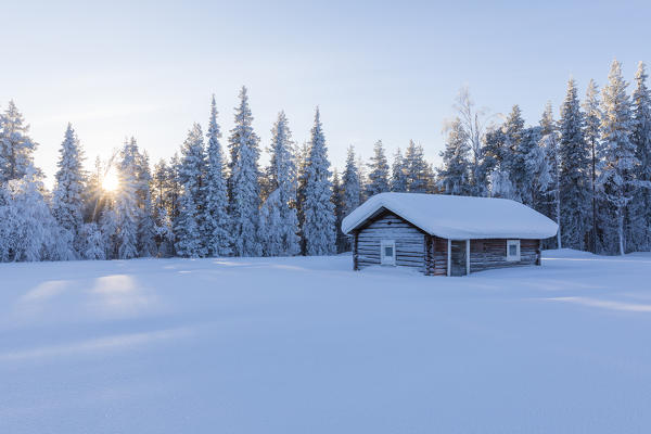 Wooden hut in the snowy forest, Kiruna, Norrbotten County, Lapland, Sweden