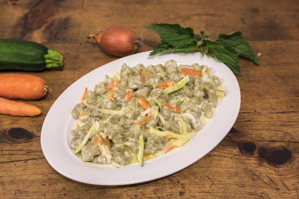 Plate of gnocchi with vegetables and cheese, San Romerio Alp, Brusio, Canton of Graubünden, Poschiavo valley, Switzerland