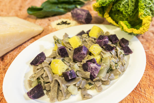 Plate of pasta with vegetables and cheese, San Romerio Alp, Brusio, Canton of Graubünden, Poschiavo valley, Switzerland