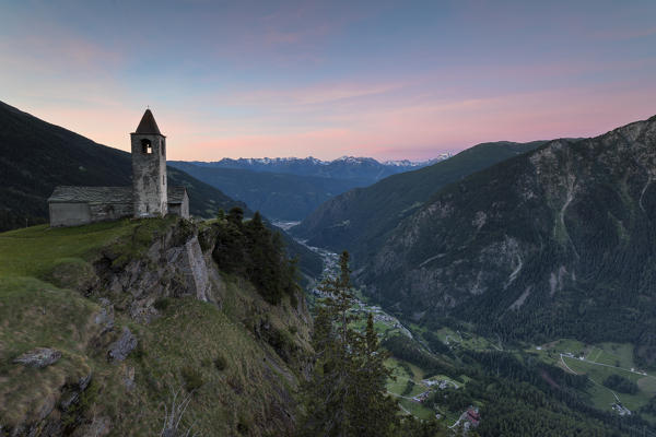 Ancient church at sunrise, San Romerio Alp, Brusio, Canton of Graubünden, Poschiavo valley, Switzerland