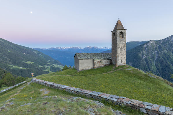 Ancient church at dusk, San Romerio Alp, Brusio, Canton of Graubünden, Poschiavo valley, Switzerland