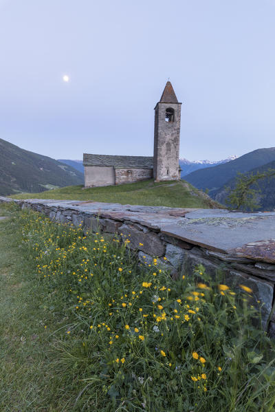 Ancient church at dusk, San Romerio Alp, Brusio, Canton of Graubünden, Poschiavo valley, Switzerland