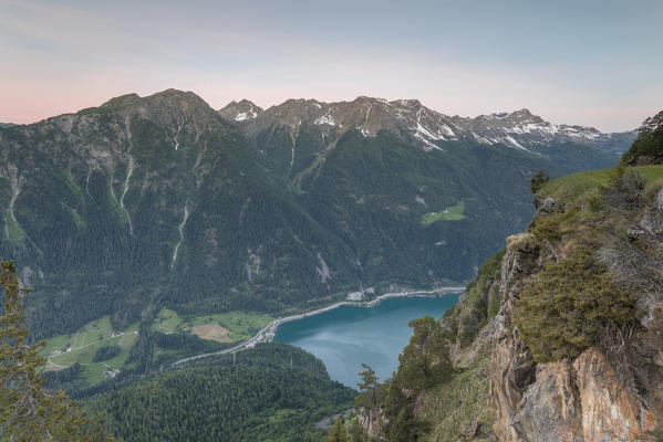 Overview of rocky peaks and lake at dawn, San Romerio Alp, Brusio, Canton of Graubünden, Poschiavo valley, Switzerland