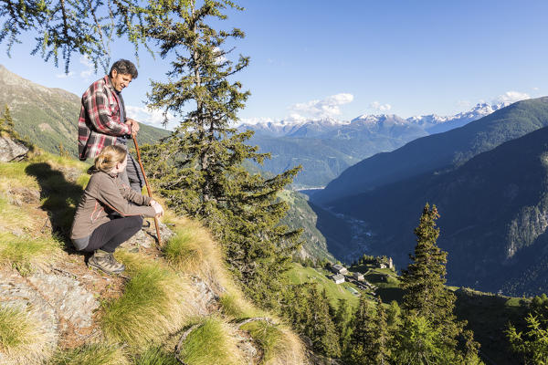 Hikers on Sentiero del Carbonaio, San Romerio Alp, Brusio, Canton of Graubünden, Poschiavo valley, Switzerland