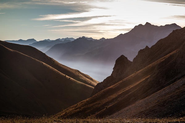 A suggestive shot of the profiles of the Val di Sole in the early morning lights - Val di Sole, Camonica valley Lombardy, Italy. Europe