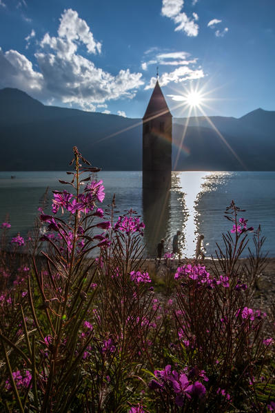 Lake Reschen is an artificial lake in the western portion of South Tyrol, Italy, south of the Reschen Pass, which forms the border with Austria, and east of the mountain ridge forming the border with Switzerland. The lake is famous for the steeple of a submerged 14th-century church; when the water freezes, this can be reached on foot. 