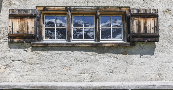 Details of wooden window of a typical alpine house in Davos, Sertig Valley, canton of Graubünden, Switzerland