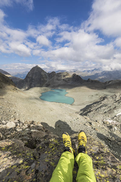 Hiker lies on rocks around  Lej Lagrev, Silvaplana, canton of Graubünden, Engadine, Switzerland