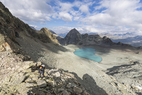 Hiker on rocks around Lej Lagrev, Silvaplana, canton of Graubünden, Engadine, Switzerland