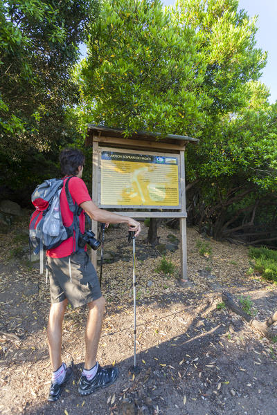 Hiker looks the signage to ascend the Monte Capanne, Elba Island, Livorno Province, Tuscany, Italy