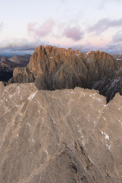 Aerial view of Sassolungo and Sassopiatto mountain range at sunset, Dolomites, South Tyrol, Italy