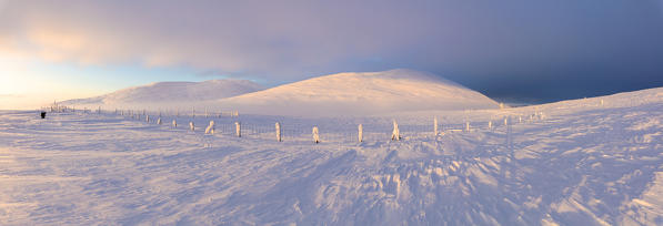 Panoramic of snow covered mountains at dusk, Pallas-Yllastunturi National Park, Muonio, Lapland, Finland